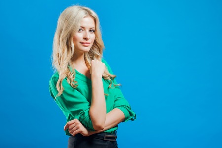 Portrait of a young confident blonde, casual style, blue backgroundの写真素材