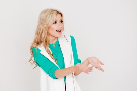 Young woman's portrait with happy emotions on grey background.の写真素材