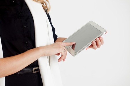 Portrait of young confident business lady, use the tablet, white backgroundの写真素材