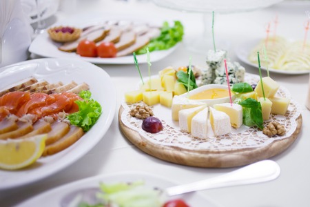 Appetizers. Various types of cheese, salami and prosciuttoの写真素材
