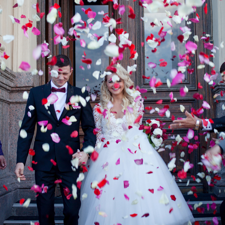 Beautiful young couple, bride and groom. Luxurious light interiorの写真素材