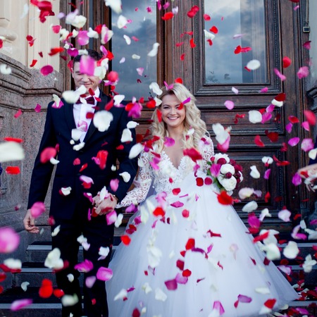 Beautiful young couple, bride and groom. Luxurious light interiorの写真素材