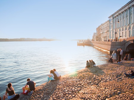 SAINT PETERSBURG, RUSSIA - March 07, 2016: Waterfront of the Neva river, people relax and greet the dawn, white nightsのeditorial素材