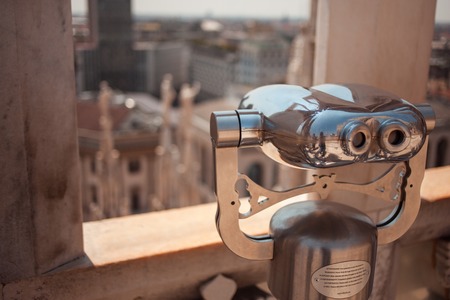 Binoculars on the roof of the Duomo in Milan, Italy. Top view of cityの写真素材