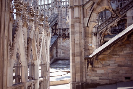 White marble statues on the roof of famous Cathedral Duomo di Milano on piazza in Milan, Italyの写真素材