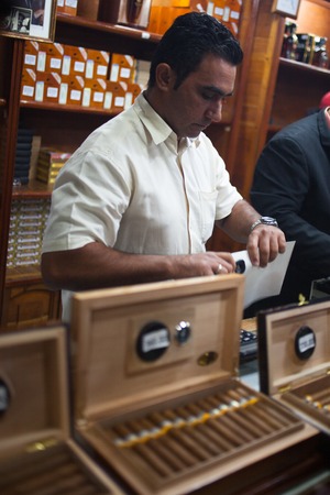 HAVANA, CUBA - NOVEMBER 3, 2012: A man sells Cuban cigars, tobacco factoryのeditorial素材