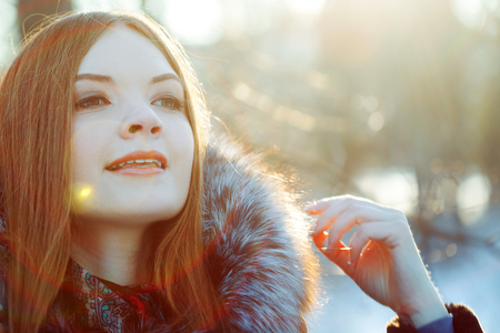 Young and attractive woman on walk, winter, warm coat with a hoodの写真素材