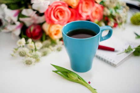 Cup of tea on the table, relax. Workshop florist, table with flowers, still life. Soft focusの写真素材