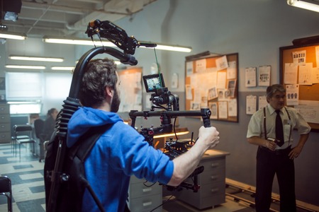 SAINT PETERSBURG, RUSSIA - AUGUST 20, 2016: Film Crew On Location. 4K Camera & Cinematographer. Filmmaking. Set, scenery police stationのeditorial素材