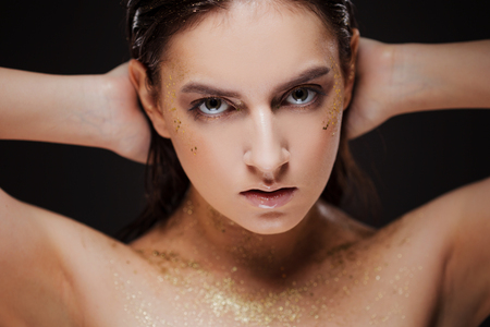 Close up portrait of beautiful woman with creative gold make upの写真素材