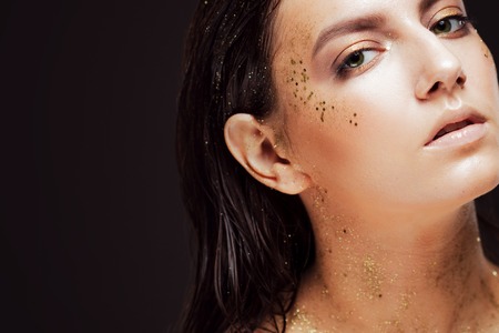 Close up portrait of beautiful woman with creative gold make upの写真素材