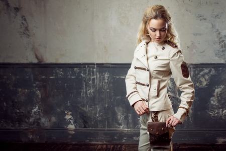 Portrait of a beautiful steampunk woman over grunge background.の写真素材