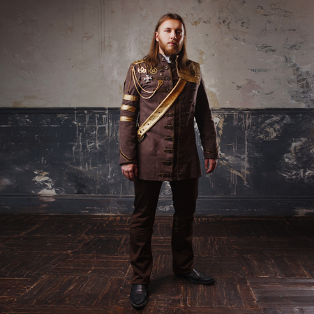 Handsome male Steam punk. Retro man in uniform, portrait over grunge background.の写真素材