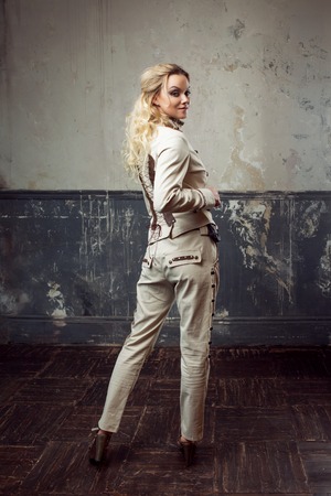 Portrait of a beautiful steampunk woman over grunge background.の写真素材