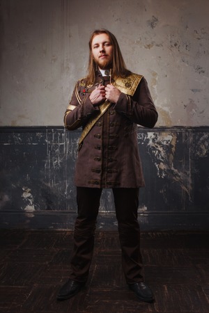 Handsome male Steam punk. Retro man in uniform, portrait over grunge background.の写真素材