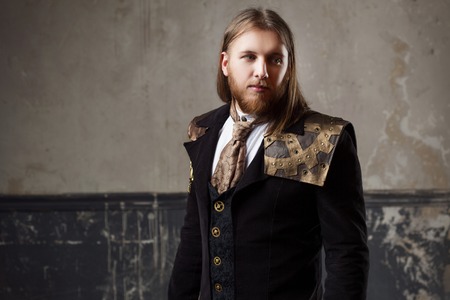 Handsome male Steam punk. Retro man in uniform, portrait over grunge background.の写真素材