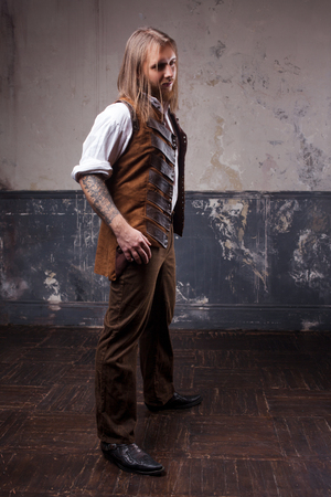 Handsome male Steam punk. Retro man portrait over grunge background.の写真素材