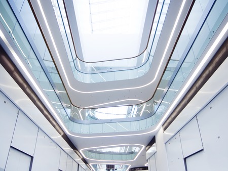 Interior of the modern building, shopping mall background. look on the atrium of modern commercial or business center. Glass, metal, modern construction technologyの写真素材