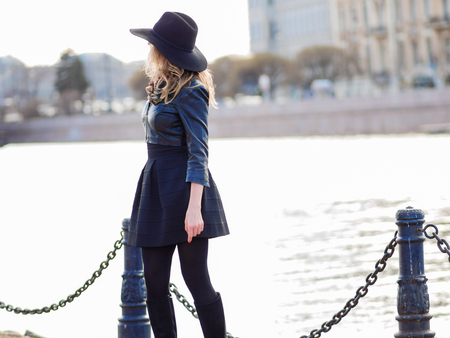 Young woman in stylish clothes against the background of the city, romantic portrait. Portrait of the charming blonde on the street.の写真素材