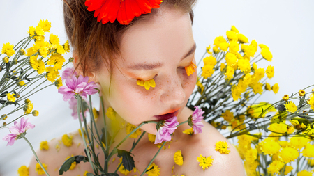 Beautiful young girl in the image of flora, close-up portraitの写真素材