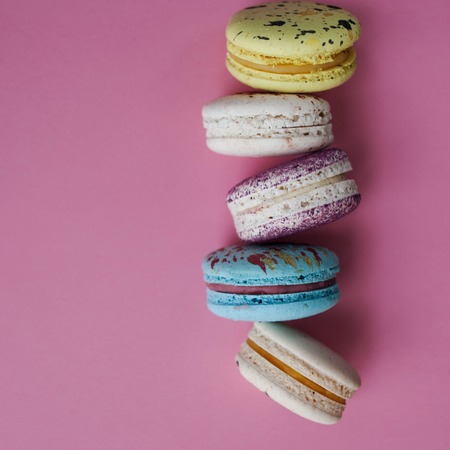 lot of beautiful macarons pink background in lineの写真素材