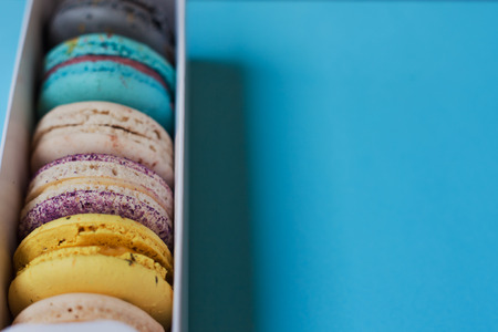 Lot of beautiful macarons. View from the top. In box on a blue backgroundの写真素材
