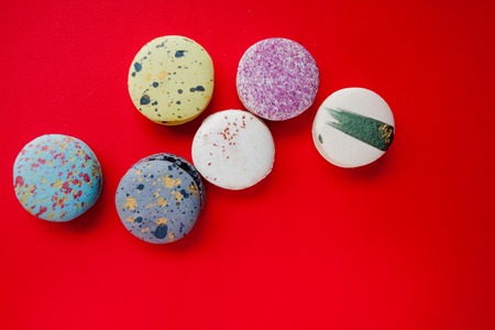 Lot of macarons, red background, top viewの写真素材