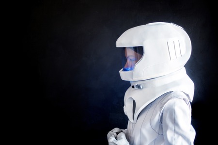 Female astronaut looking left on something. Fantastic space suit. Exploration of outer space.の写真素材