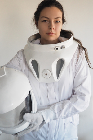 Female astronaut on a white background. Fantastic space suit. Exploration of outer space.の写真素材