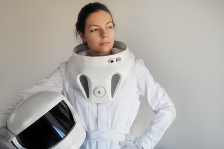 Female astronaut on a white background. Fantastic space suit. Exploration of outer space.の写真素材