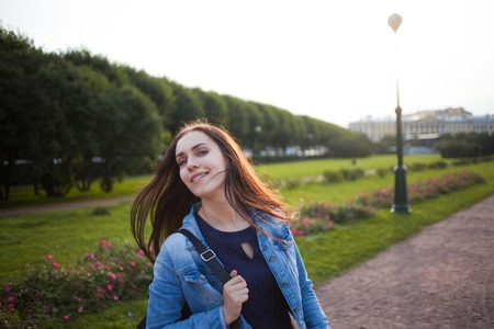 Beautiful young brunette girl student on the walkの写真素材