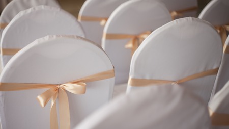 decorated chairs in restaurant, lot in a row, prepare for the celebrationの写真素材