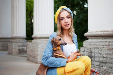 Stylish lady in yellow pants, blue jacket and turbanの写真素材