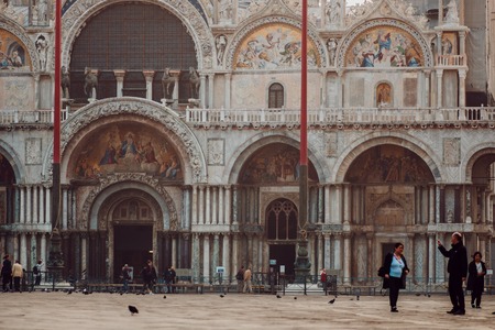 VENICE, ITALY - OCTOBER 6 , 2017: Basilica di San Marco, Tourists walk on square