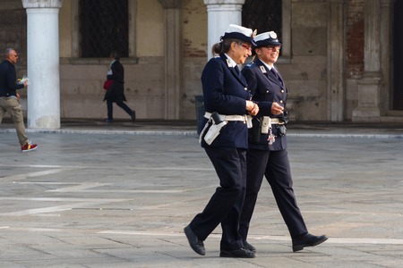 VENICE, ITALY - OCTOBER 6 , 2017: Two women police officers are on the square San Marcoのeditorial素材