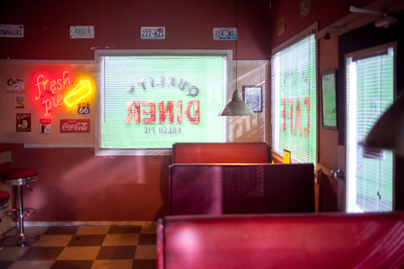 SAINT PETERSBURG, RUSSIA - JULY 22, 2017: Film Crew On Location with 4K Camera Cinematographer at 80s style cafe.のeditorial素材