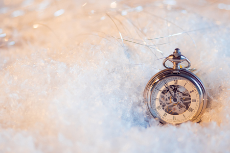Festive background, antique clock in the snowの写真素材