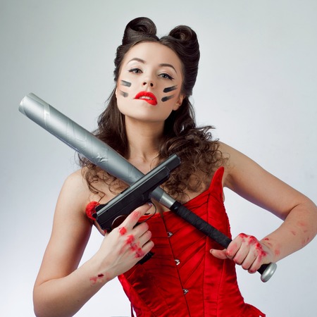 Charming lady in war paint, girl power. Babe with a bat is seriousの写真素材