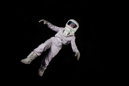 Astronaut in space, in zero gravity on black background. Man in space, fallingの写真素材
