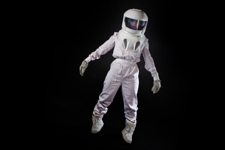 Astronaut in space, in zero gravity on black background. Man in space, fallingの写真素材