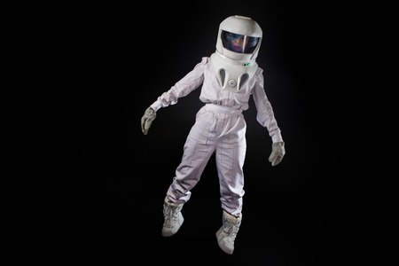 Astronaut in space, in zero gravity on black background. Man in space, fallingの素材 [FY31095527769]