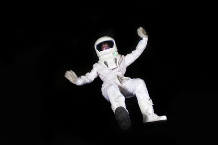 Astronaut in space, in zero gravity on black background. Man in space, fallingの写真素材