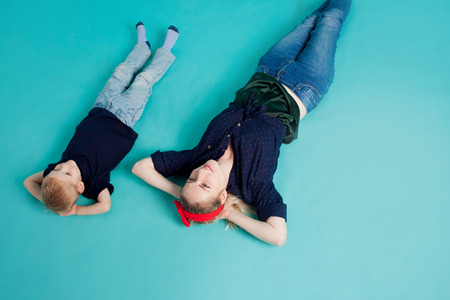 Mom and sons, portrait on blue background. A large and cheerful familyの写真素材