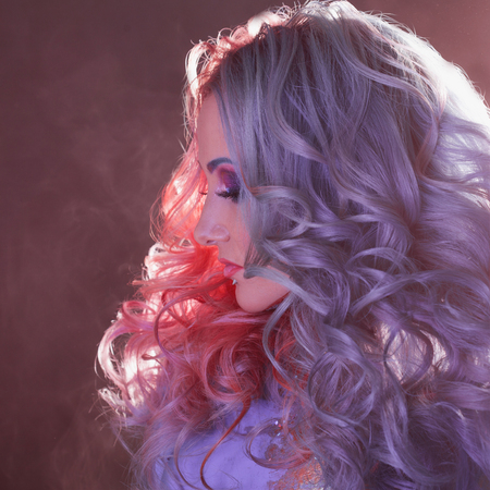 Beautiful woman with bright hair. Bright hair color, hairstyle with the curls.の写真素材