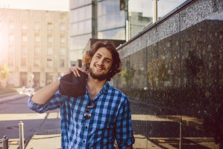 Portrait of young handsome stylish man on the street.の写真素材