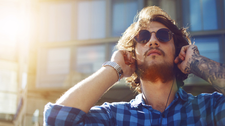 Portrait of young handsome stylish man on the street.の写真素材