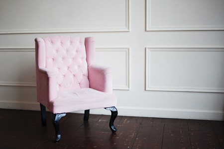 Pink armchair against the wall. Perspective distortion and free spaceの写真素材