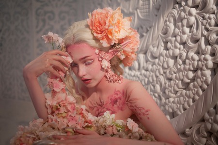 lovely she-elf among flowers. Creative make-up and bodyart. Girl with Elvish ears. Fantasy style.の写真素材