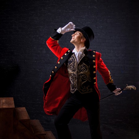 Showman. Young male entertainer, presenter or actor on stage. The guy in the red camisole and the...