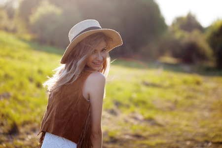 Cute charming girl in summer in the field. Young woman is happy and feels free, outdoorsの写真素材